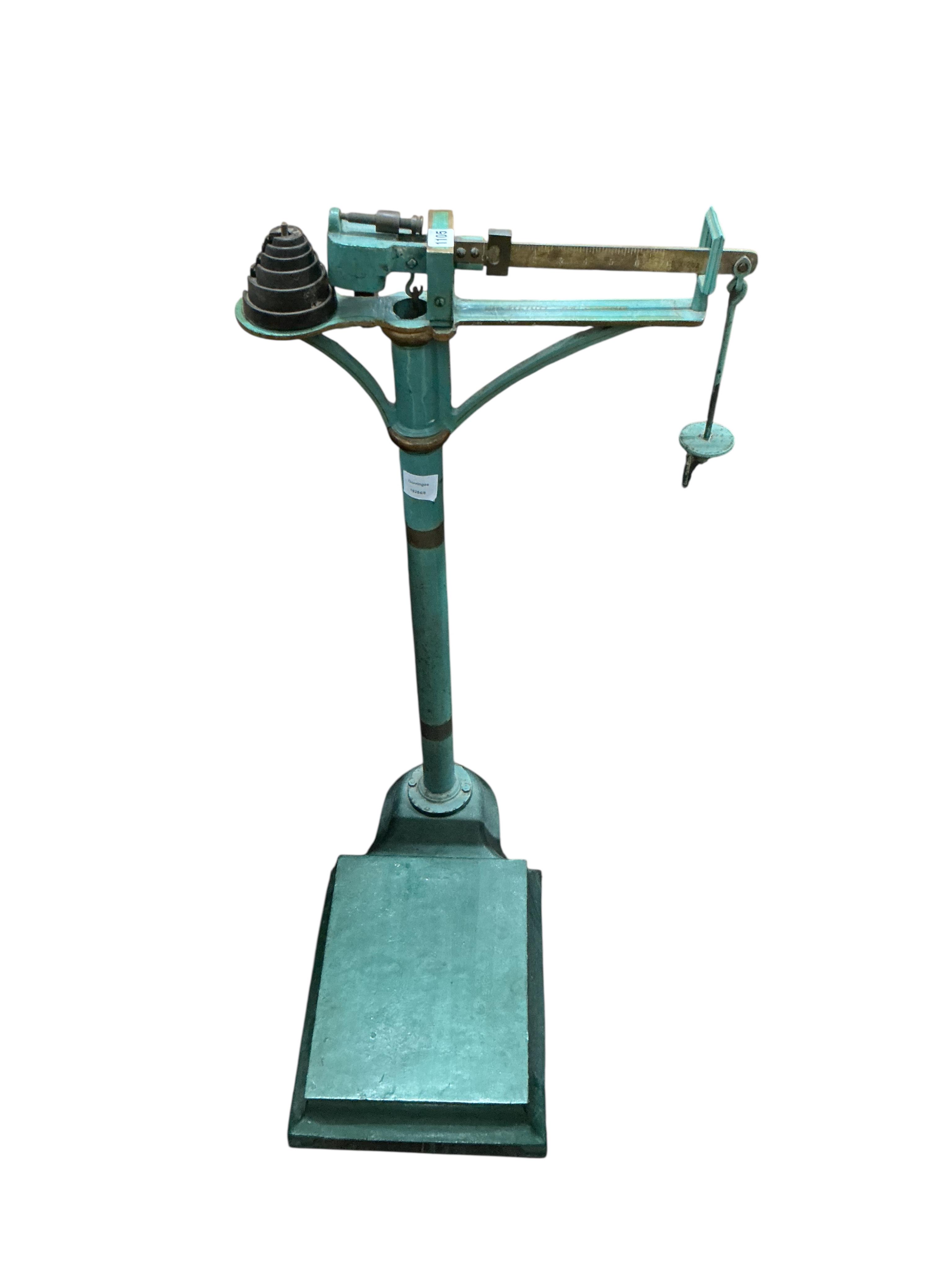 A set of late Victorian green painted cast iron medical scales and weights, height 93cm